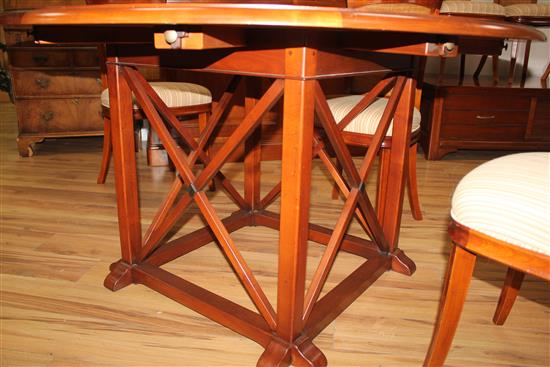 A 20th century French cherrywood radially extending dining table, the circular table extends to 6ft 7in.